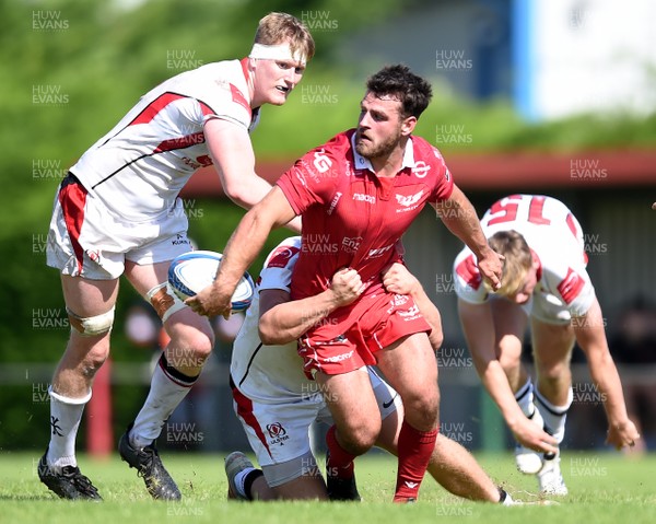 240819 - Scarlets A v Ulster A - Celtic Cup - Rhodri Jones of Scarlets A is tackled by Zack McCall