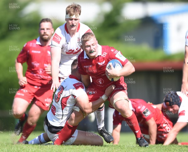 240819 - Scarlets A v Ulster A - Celtic Cup - Jac Morgan of Scarlets A is tackled by Hayden Hyde