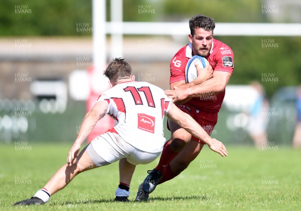 240819 - Scarlets A v Ulster A - Celtic Cup - Rhodri Jones of Scarlets A is tackled by Graham Curtis