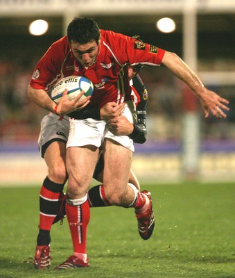 27.10.06...Llanelli Scarlets v Ulster, Heineken Cup Rugby Scarlets' Stephen Jones is held by David Humphreys 