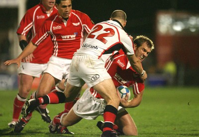 27.10.06...Llanelli Scarlets v Ulster, Heineken Cup Rugby Scarlets Dafydd James is stopped by Scott Young 