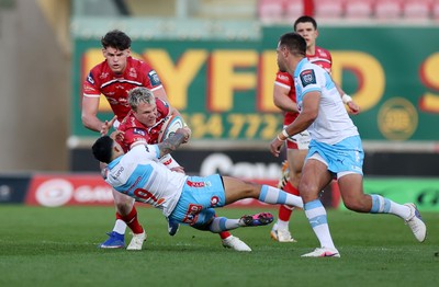 250426 - Scarlets v Vodacom Bulls - United Rugby Championship - Blair Murray of Scarlets is tackled by Embrose Papier of Bulls 