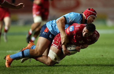 270123 - Scarlets v Vodacom Bulls - United Rugby Championship - Dan Davis of Scarlets is tackled by Johan Grobbelaar of Bulls