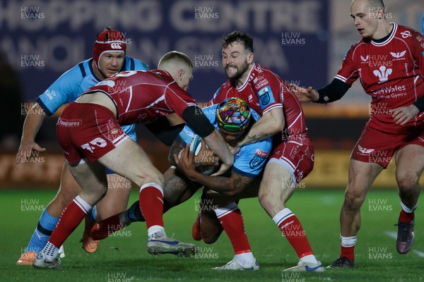 270123 - Scarlets v Vodacom Bulls - United Rugby Championship - Lionel Mapoe of Blue Bulls is tackled by Johnny McNicholl and Ryan Conbeer of Scarlets