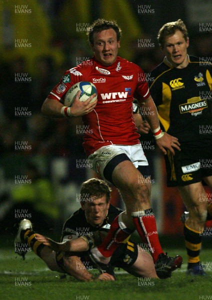 17.11.07 Llanelli  v Wasps... Llanelli's Morgan Stoddart leaves  Wasps' Tom Rees grounded.. 