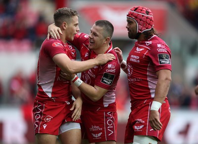 121019 - Scarlets v Zebre Rugby - Guinness PRO14 - Kieran Hardy of Scarlets celebrates scoring a try with Steff Evans and Josh Macleod