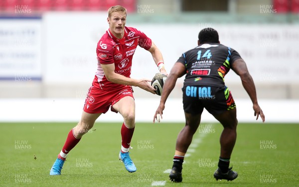 121019 - Scarlets v Zebre Rugby - Guinness PRO14 - Johnny McNicholl of Scarlets is challenged by Paula Balekana of Zebre