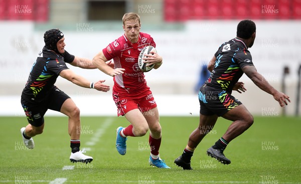 121019 - Scarlets v Zebre Rugby - Guinness PRO14 - Johnny McNicholl of Scarlets is challenged by Jamie Elliott and Paula Balekana of Zebre