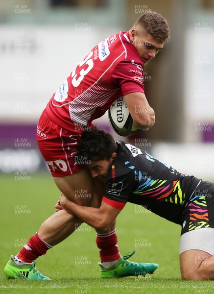 121019 - Scarlets v Zebre Rugby - Guinness PRO14 - Corey Baldwin of Scarlets is tackled by Nicolo Casilio of Zebre