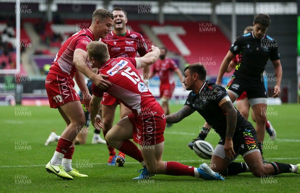 121019 - Scarlets v Zebre Rugby - Guinness PRO14 - Johnny McNicholl of Scarlets celebrates scoring a try with team mates