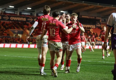 200326 - Scarlets v Zebre Parma - United Rugby Championship - Ellis Mee of Scarlets celebrates scoring a try with team mates