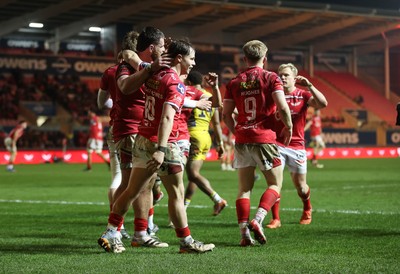 200326 - Scarlets v Zebre Parma - United Rugby Championship - Ellis Mee of Scarlets celebrates scoring a try with team mates