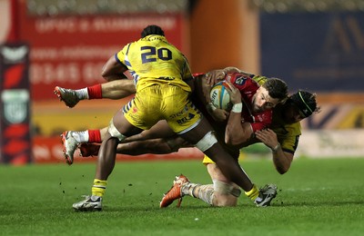 200326 - Scarlets v Zebre Parma - United Rugby Championship - Johnny Williams of Scarlets is tackled by Alessandro Ortombina and Davide Odiase of Zebre 