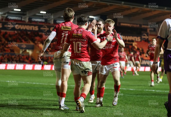 200326 - Scarlets v Zebre Parma - United Rugby Championship - Ellis Mee of Scarlets celebrates scoring a try with team mates