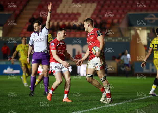 200326 - Scarlets v Zebre Parma - United Rugby Championship - Jarrod Taylor of Scarlets celebrates scoring a try with team mates