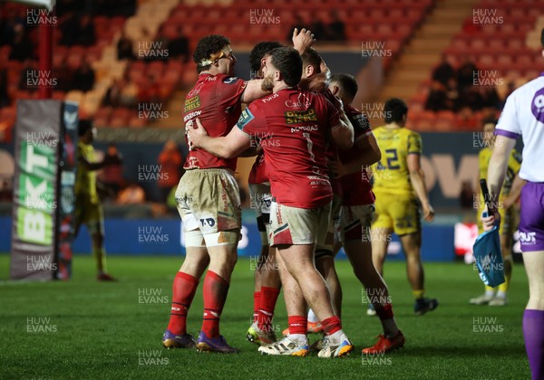 200326 - Scarlets v Zebre Parma - United Rugby Championship - Jarrod Taylor of Scarlets celebrates scoring a try with team mates