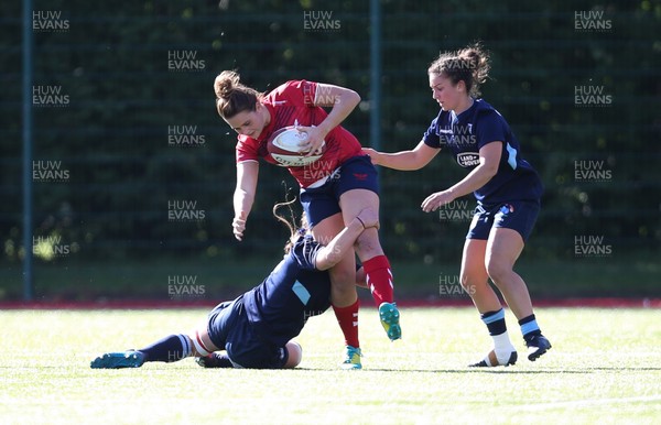 230918 - Scarlets Women v Cardiff Blues Women - Jodie Evans of Scarlets is tackled