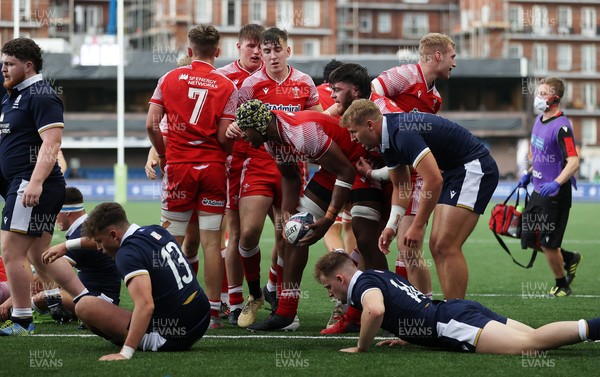 130721 - Wales U20s v Scotland U20s - Christ Tshiunza of Wales celebrates scoring a try with team mates