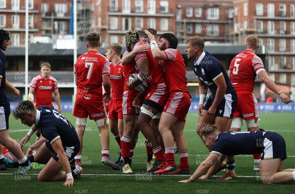 130721 - Wales U20s v Scotland U20s - Christ Tshiunza of Wales celebrates scoring a try with team mates
