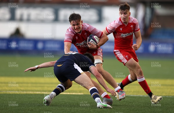 130721 - Wales U20s v Scotland U20s - Alex Mann of Wales is tackled by Cameron Scott of Scotland