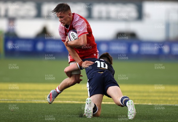 130721 - Wales U20s v Scotland U20s - Alex Mann of Wales is tackled by Cameron Scott of Scotland