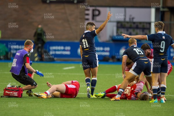 130721 - Wales U20 v Scotland U20 - Under 20 Six Nations  - Ollie Meville of Scotland calls the referee's attention to an injury to Carrick McDonough of Wales