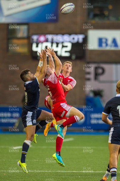 130721 - Wales U20 v Scotland U20 - Under 20 Six Nations  - Ollie Meville of Scotland competes with Morgan Richards of Wales and Carrick McDonough of Wales for the high ball
