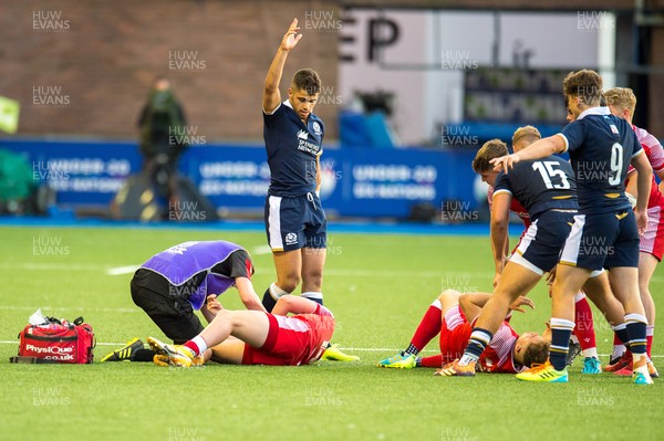 130721 - Wales U20 v Scotland U20 - Under 20 Six Nations  - Ollie Meville of Scotland calls the referees attention to an injury to Carrick McDonough of Wales