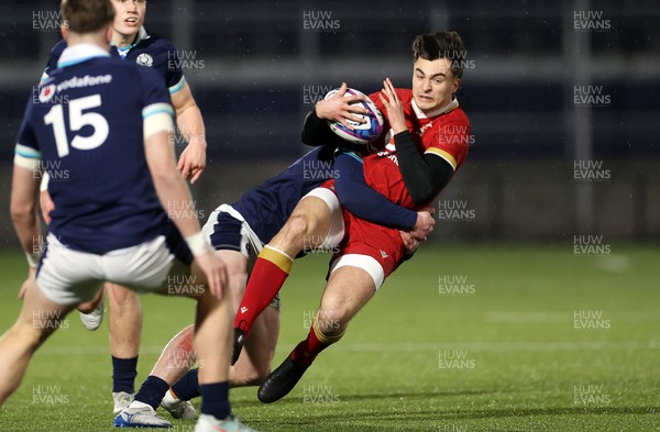 070325 - Scotland U20s v Wales U20s - U20s 6 Nations Championship - Elijah Evans of Wales is tackled by Fergus Watson of Scotland 