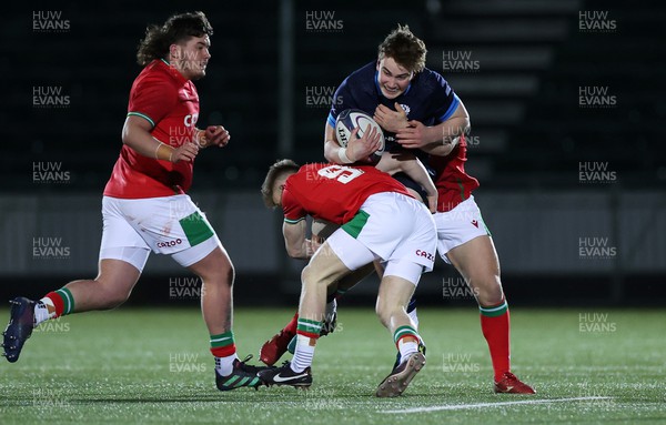 100223 - Scotland U20s v Wales U20s - U20s 6 Nations Championship - Kerr Yule of Scotland is tackled by Archie Hughes and Dan Edwards of Wales 