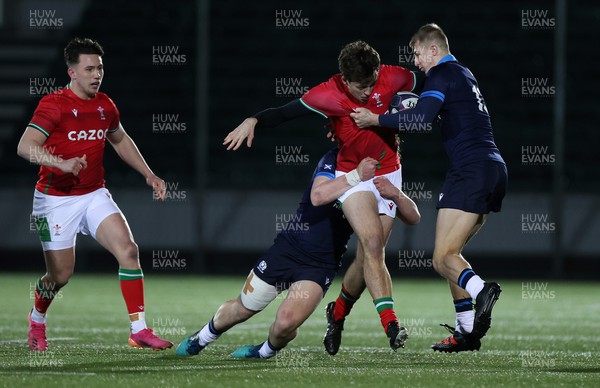 100223 - Scotland U20s v Wales U20s - U20s 6 Nations Championship - Louie Hennessey of Wales is tackled by Kerr Yule and Duncan Munn of Scotland