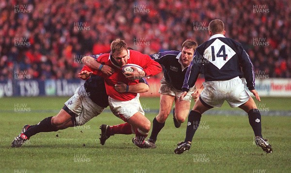 060299 - Scotland v Wales - Five Nations - Scott Quinnell of Wales is tackled by Gregor Townsend