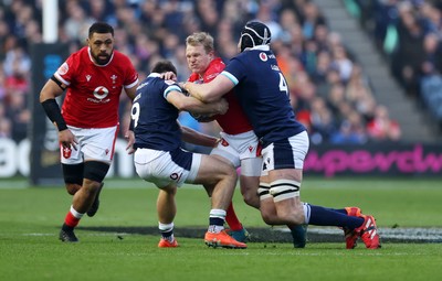 080325 - Scotland v Wales - Guinness 6 Nations Championship - Blair Murray of Wales is tackled by Ben White and Jonny Gray of Scotland 