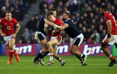 080325 - Scotland v Wales - Guinness 6 Nations Championship - Ellis Mee of Wales is tackled by Jack Dempsey and Rory Darge of Scotland 