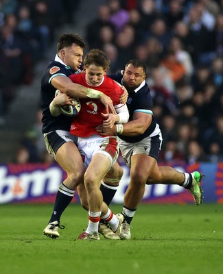 080325 - Scotland v Wales - Guinness 6 Nations Championship - Ellis Mee of Wales is tackled by Jack Dempsey and Rory Darge of Scotland 