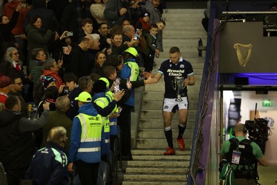 080325 - Scotland v Wales - Guinness 6 Nations Championship - Gareth Anscombe of Wales lifts the Doddie Weir Cup