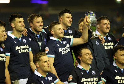 080325 - Scotland v Wales - Guinness 6 Nations Championship - Gareth Anscombe of Wales lifts the Doddie Weir Cup