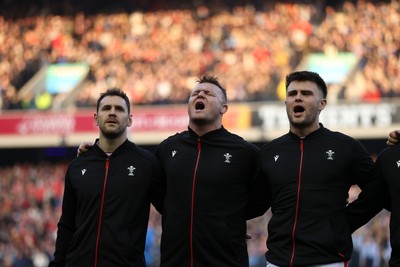 080325 - Scotland v Wales - Guinness 6 Nations Championship - Tomos Williams, Dewi Lake and Joe Roberts sing the anthem