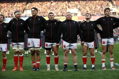 080325 - Scotland v Wales - Guinness 6 Nations Championship - Aaron Wainwright, Teddy Williams, Elliot Dee, Keiron Assiratti, Jarrod Evans and Ellis Mee sing the anthem