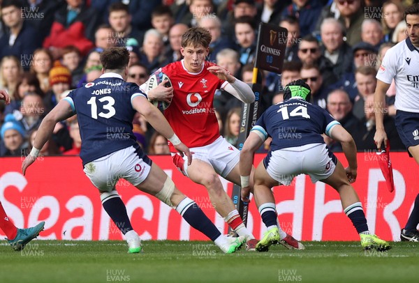 080325 - Scotland v Wales - Guinness 6 Nations Championship - Ellis Mee of Wales is challenged by Huw Jones and Darcy Graham of Scotland 