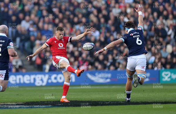 080325 - Scotland v Wales - Guinness 6 Nations Championship - Gareth Anscombe of Wales kicks the ball over Jamie Ritchie of Scotland 