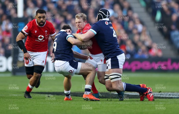 080325 - Scotland v Wales - Guinness 6 Nations Championship - Blair Murray of Wales is tackled by Ben White and Jonny Gray of Scotland 