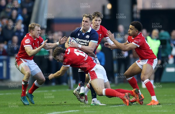 080325 - Scotland v Wales - Guinness 6 Nations Championship - Duhan van der Merwe of Scotland is tackled by Blair Murray, Max Llewellyn, Ellis Mee and Ben Thomas of Wales 