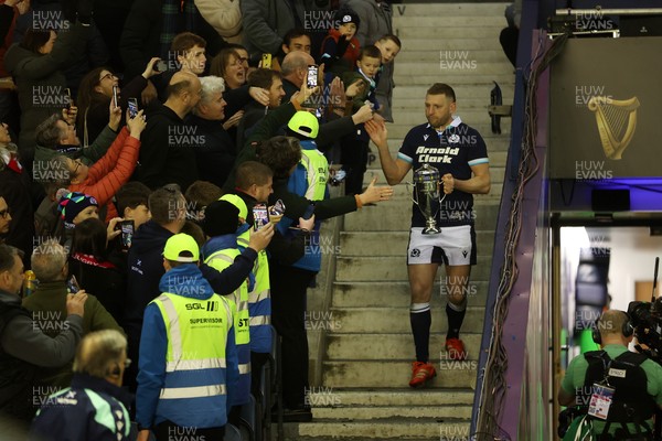 080325 - Scotland v Wales - Guinness 6 Nations Championship - Gareth Anscombe of Wales lifts the Doddie Weir Cup