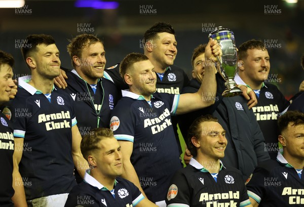 080325 - Scotland v Wales - Guinness 6 Nations Championship - Gareth Anscombe of Wales lifts the Doddie Weir Cup