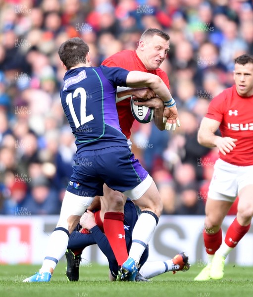 090319 - Scotland v Wales - Guinness Six Nations - Hadleigh Parkes of Wales is tackled by Pete Horne of Scotland