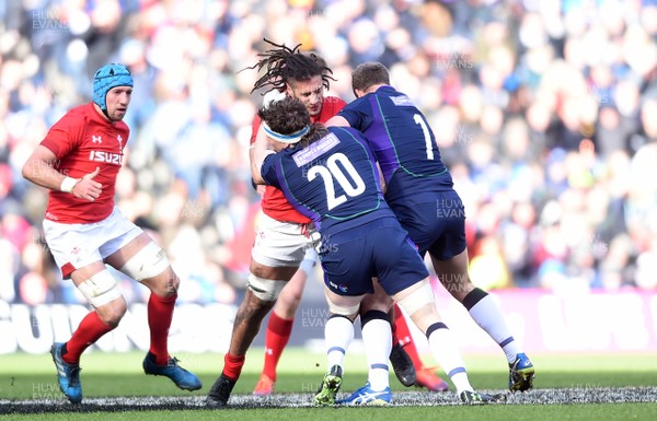 090319 - Scotland v Wales - Guinness Six Nations - Josh Navidi of Wales is tackled by Hamish Watson and Jamie Ritchie of Scotland