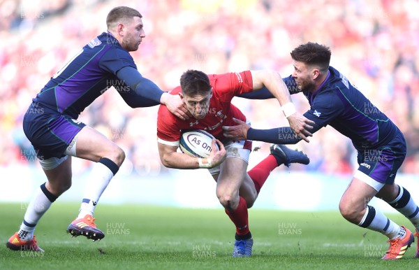 090319 - Scotland v Wales - Guinness Six Nations - Josh Adams of Wales is tackled by Finn Russell and Ali Price of Scotland