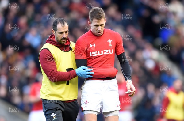 090319 - Scotland v Wales - Guinness Six Nations - Liam Williams of Wales leaves the field with physio John Miles