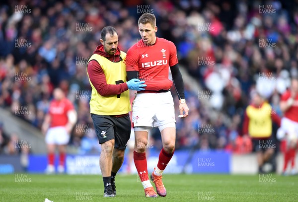 090319 - Scotland v Wales - Guinness Six Nations - Liam Williams of Wales leaves the field with physio John Miles